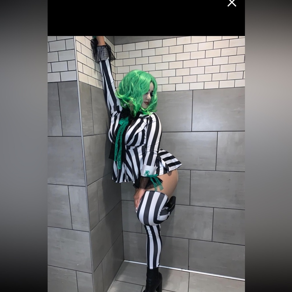 striped jacket and leg accessories coordinating cami, panty, tie, and green wig.